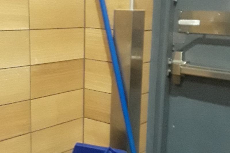 Blue mop and bucket in a service area
